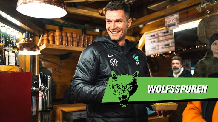 Wolfsspuren mit VfL-Wolfsburg-Torhüter Pavao Pervan mit einer Bratwurst und Glühwein auf dem Weihnachtsmarkt.