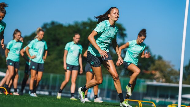 Joelle Wedemeyer vom VfL Wolfsburg läuft mit ihren Teamkolleginnen auf dem Trainigsplatz.