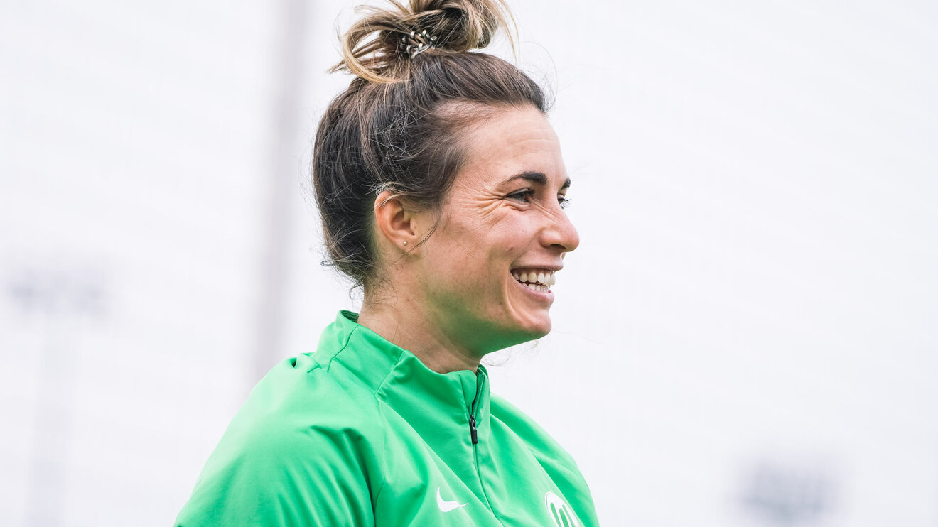 Die ehemalige VfL Wolfsburg Spielerin Sandra Starke schaut nach rechts und lächelt.