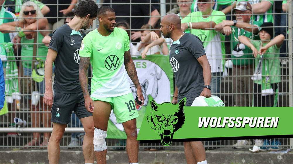 Eine Grafik, auf der VfL-Wolfsburg-Spieler Lukas Nmecha mit zwei Physiotherapeuten spricht und rechts unten der Schriftzug "Wolfsspur" steht.