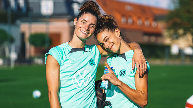 Die VfL-Wolfsburg-Spielerinnen Dominique Janssen und Felicitas Rauch halten sich lachend in den Armen.