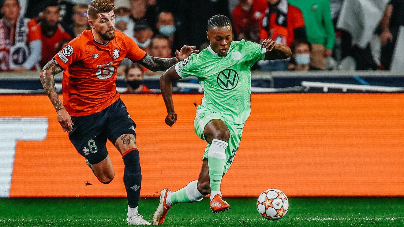 VfL-Wolfsburg-Spieler Ridle Baku im Zweikampf mit einem Gegenspieler.