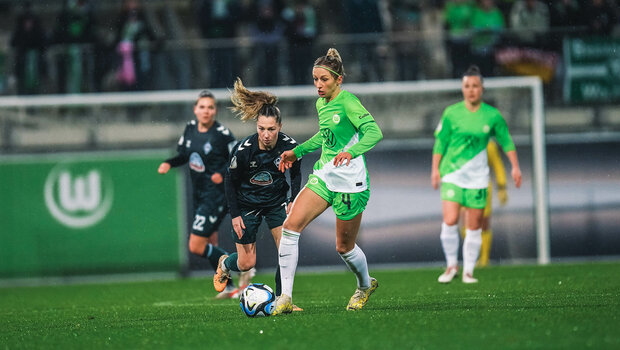 VfL Wolfsburg Spielerin Hendrich läuft mit dem Ball am Fuß über den Platz, die Gegnerinnen an ihrem Fersen.