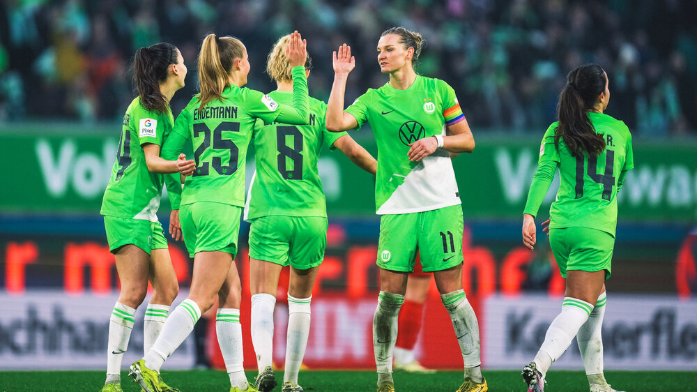 Alexandra Popp jubelt auf dem Spielfeld mit ihren Spielkolleginnen vom VfL Wolfsburg.
