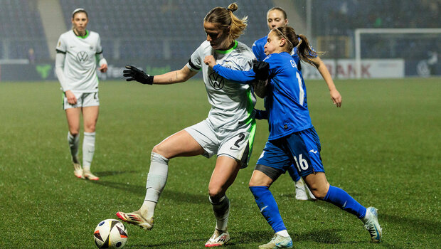 Zweikampf: Lynn Wilms vom VfL-Wolfsburg ist mit dem rechten Fuß am Ball. Hinter ihr ihre Gegenspielerin Dominika Grabowska, die versucht sie aufzuhalten. Sie greift dabei mit dem Linken Arm um die Brust von Wilms. 