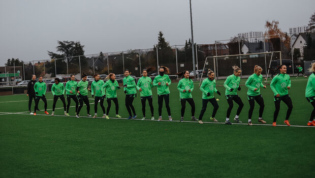 Die VfL-Frauen laufen beim Abschlusstraining vor dem Spiel gegen Galatasaray Istanbul in einer Reihe hintereinander auf der Linie des Spielfeldes.