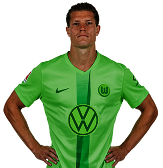 Der VfL Wolfsburg Spieler Kevin Behrens posiert mit den Händen in der Hüfte.