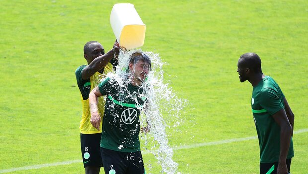 VfL-Wolfsburg-Spieler Philipp bekommt eine Wasserdusche.