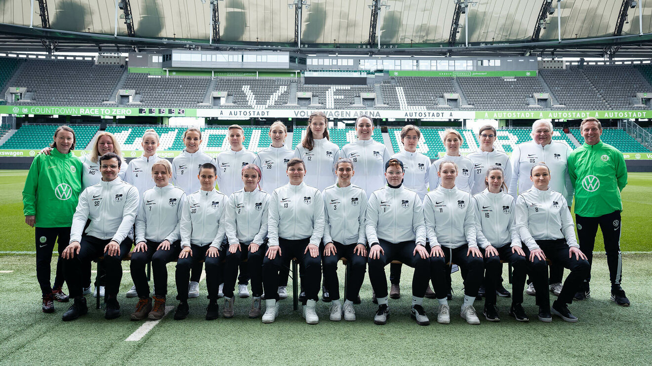 Die Frauen des 1. FC Schöningen posieren zum gemeinsamen Teamfoto mit Roy Praeger und Conny Pohlers in der Volkswagen Arena des VfL Wolfsburg.