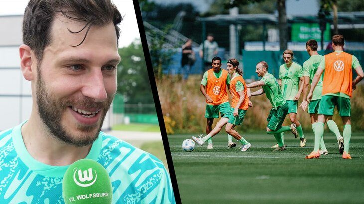 Links im Bild VfL Wolfsburg Neuzugang Marius Müller am Mikrofon. Rechts die Spieler des VfL Wolfsburg im Training.