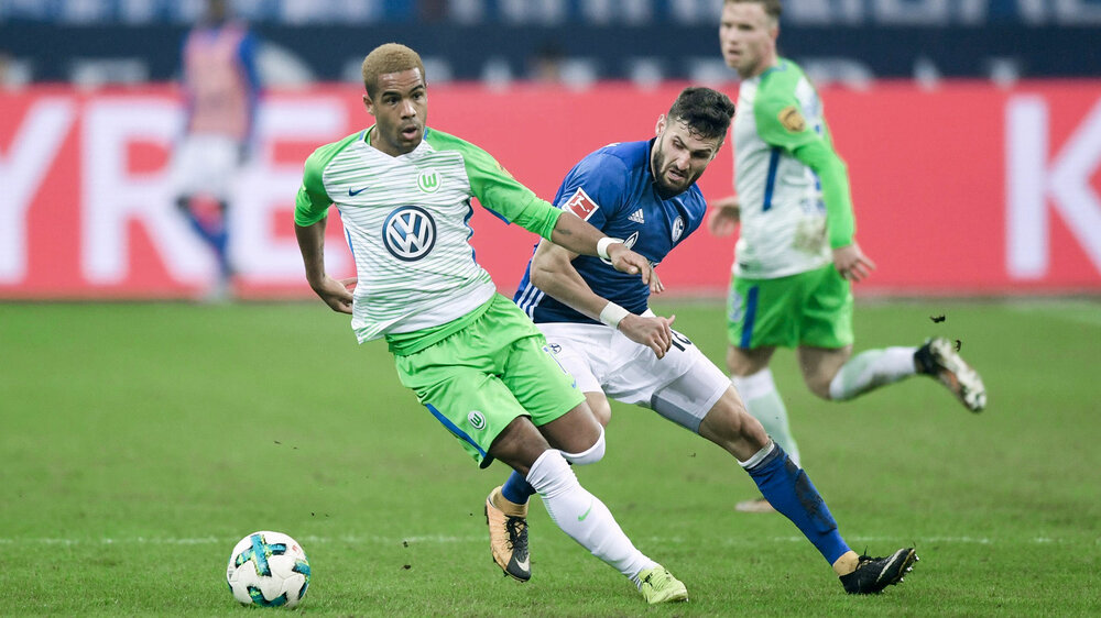 VfL Wolfsburg-Spieler Daniel Didavi im Zweikampf mit einem Schalker Gegenspieler.