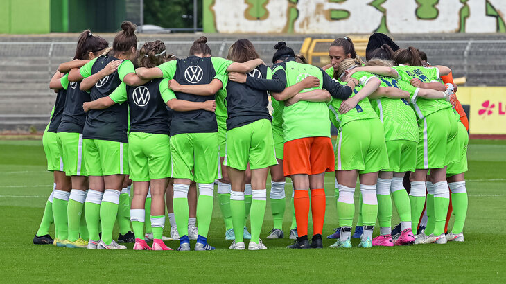 Die U20-Wölfinnen des VfL Wolfsburg bilden einen Kreis auf dem Spielfeld.