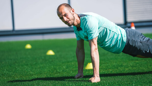 Der VfL-Wolfsburg-Spieler Vaclav Cerny macht Liegestütze.