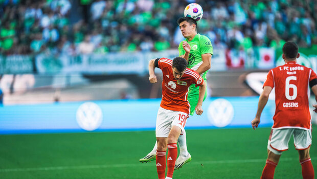 Joakim Maele vom VfL Wolfsburg springt und köpft dabei den Ball.