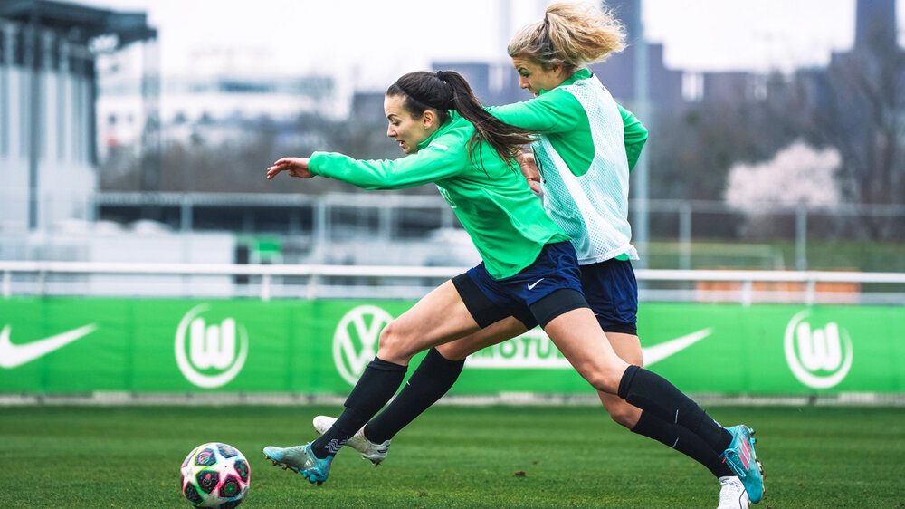 Zwei Spielerinnen des VfL-Wolfsburg führen einen Zweikampf um den Ball auf dem Trainingsgelände.