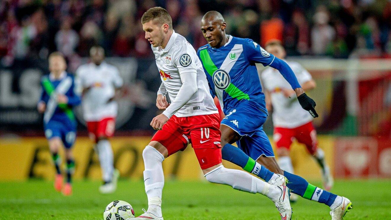 VfL Wolfsburgs Abwehrspieler Josuha Guilavogui befindet sich im Zweikampf gegen einen Gegner des RB Leipzig.
