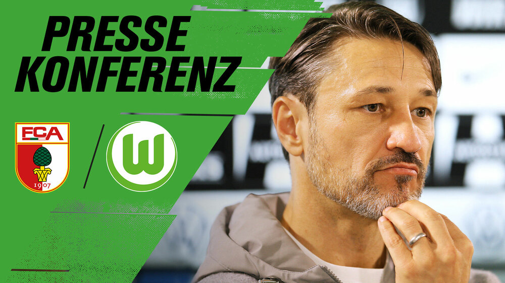 VfL Wolfsburg Trainer Niko Kovac schaut nachdenklich bei einer Pressekonferenz mit einer Hand am Kinn.