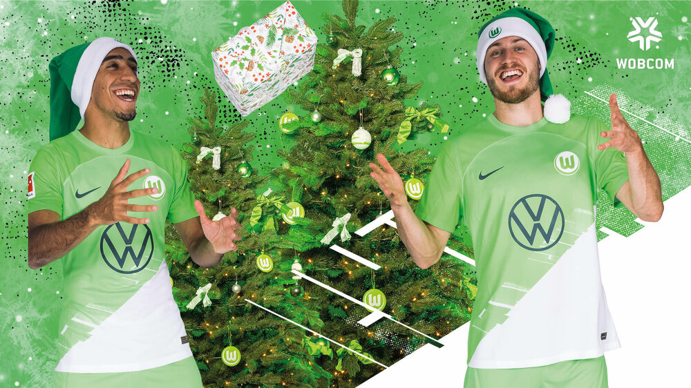 VfL-Wolfsburg-Weihnachtsgrafik mit Tiago Tomas und Mattias Svanberg, die ein Geschenk hin und her werfen.
