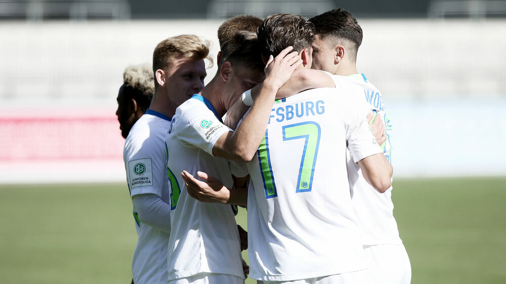 Die U19-Spieler des VfL Wolfsburg freuen und umarmen sich.