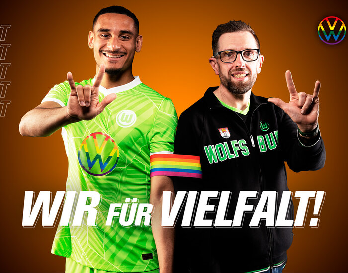 Maxence Lacroix und der gehörlose Heiko zeigen in Gebärdensprache einen Wolf und unterstreichen damit den Slogan "Wir für Vielfalt!" beim VfL Wolfsburg.