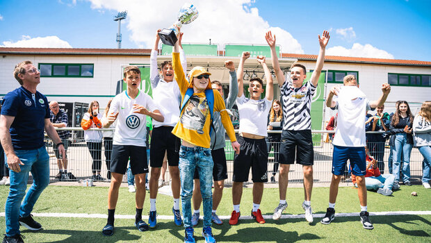 Jugendliche halten einen Pokal bei den VfL Wolfsburg Vielfaltstagen in die Höhe.